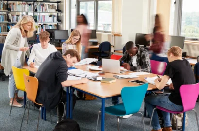 busy-college-library-with-teacher-helping-students-2024-10-19-18-38-59-utc busy-college-library-with-teacher-helping-students-2024-10-19-18-38-59-utc