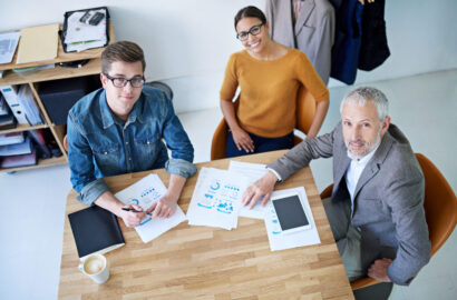 Portrait of creative businesspeople having a meeting around a table. Portrait of creative businesspeople having a meeting around a table.